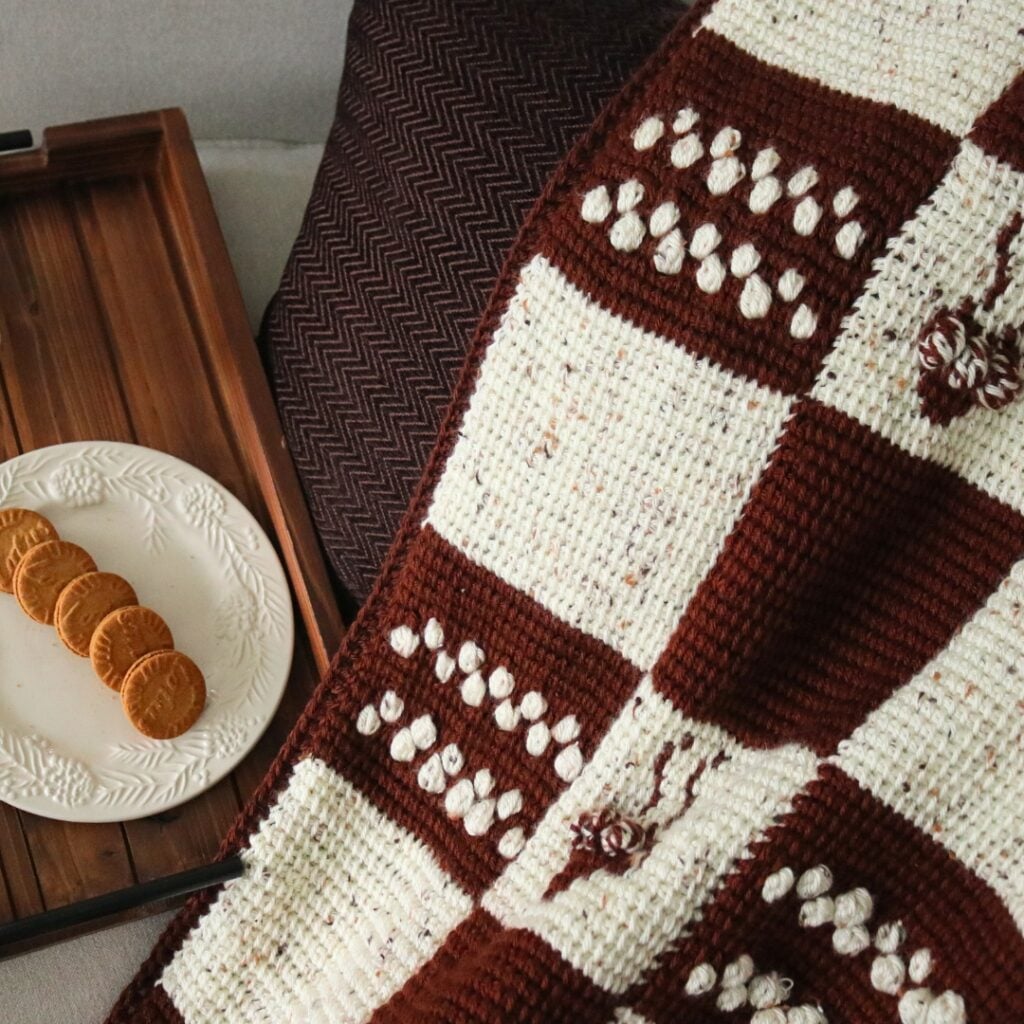 Free crochet afghan patterns featuring the cozy cocoa lapghan with Tunisian crochet stitches and crochet colorwork.