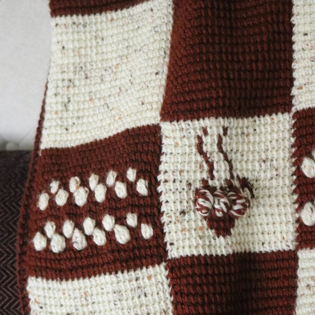 Free crochet afghan patterns featuring the cozy cocoa lapghan with Tunisian crochet stitches and crochet colorwork.