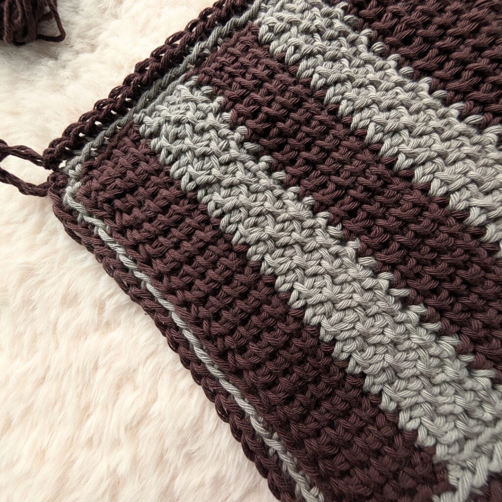 A minimalist Tunisian crochet dishcloth pattern with YouTube tutorial using the join-as-you-go method that can be completed by a beginner!